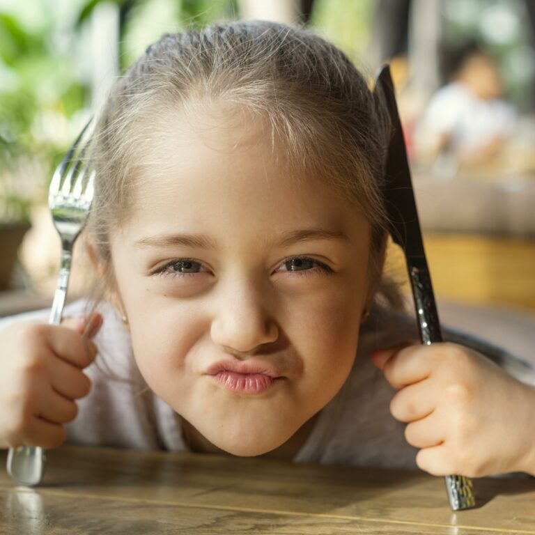 close-up-upset-girl-holding-cutlery