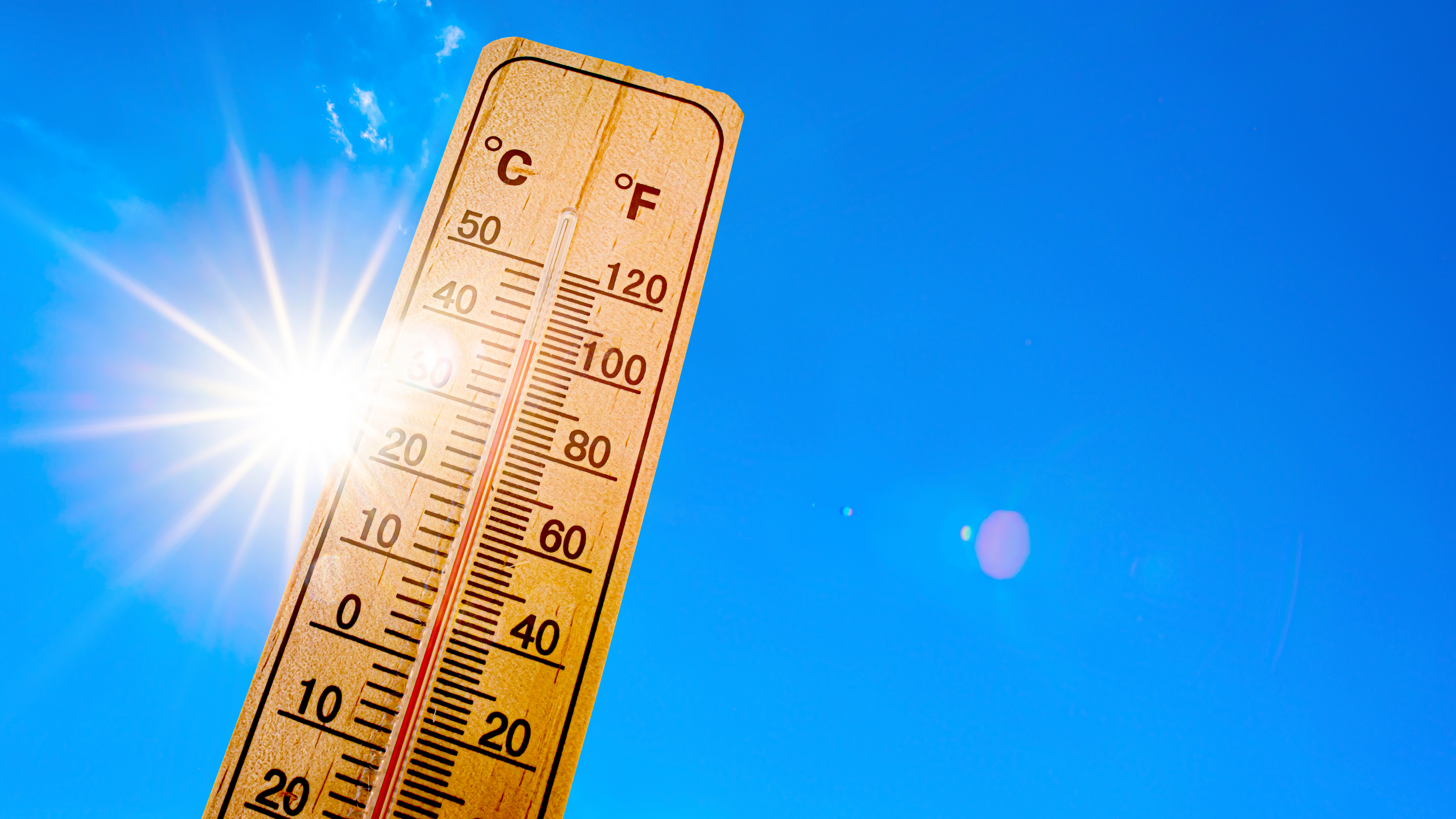 Sky with bright sun and thermometer